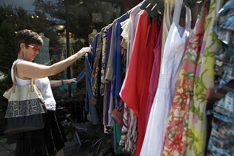 &lt;p&gt;Jani McAllister browses through a sales rack outside Festivity, a boutique in Virginia Highlands, in Atlanta on June 12.&lt;/p&gt;