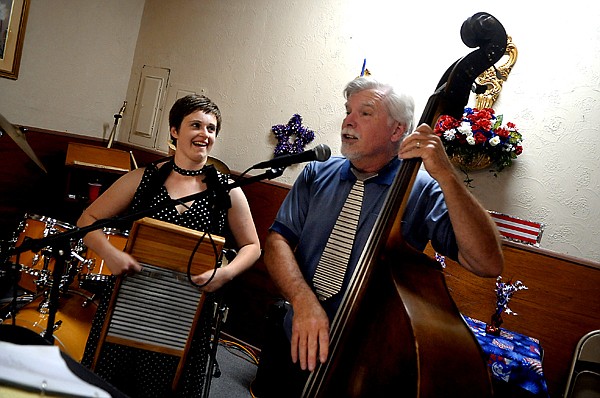 <p>Em Cohen is called up the the stage to help Rudy Rudolph of Company Brass during one of the band's songs Friday, July 20, at the North End Swing dance in Kalispell.</p>