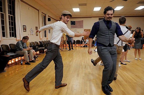 <p>Pete Milne and Joe Juneman, two of the organizers behind North End Swing, dance along to the live music provided by Company Brass July 20 at the senior center in Kalispell. This was the first time a live band had come to the weekly dance, and attendees were encouraged to dress in vintage clothing, in keeping with the 1930s and '40s musical style of the band.</p>