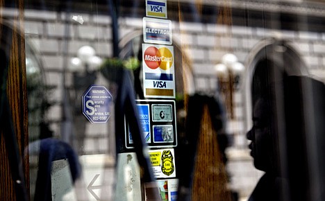 &lt;p&gt;In this July 18, 2012 photo, credit logos are seen on a downtown storefront as a pedestrian passes in Atlanta. U.S. consumers likely took on more debt in June, even as they largely kept spending in check. Economists forecast that consumer borrowing increased by $10.5 billion in June, according to a poll by FactSet. The Federal Reserve will release its report at 3 p.m. Eastern time Tuesday, Aug. 7, 2012. (AP Photo/Ashley Hopkinson)&lt;/p&gt;