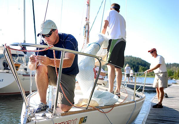 Chris Sturdevent of Billings and the crew of the Joyride, prep their boat for the Friday night races in Somers.