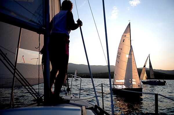 Gayle Graf of Whitefish watches the other boats during from the deck of the Howling Gayle on Tuesday night on Flathead Lake.