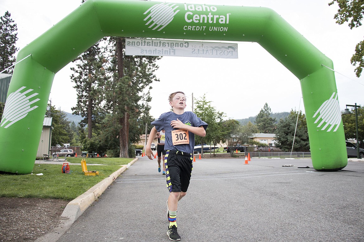 &lt;p&gt;Ryan Graves, 13, finishes the Post Falls Sprint Triathlon for his relay team. His older brother, Cody, swan the first leg of the race and his friend, Charles Sharples, did the bike section. Photo by Bethany Blitz&lt;/p&gt;