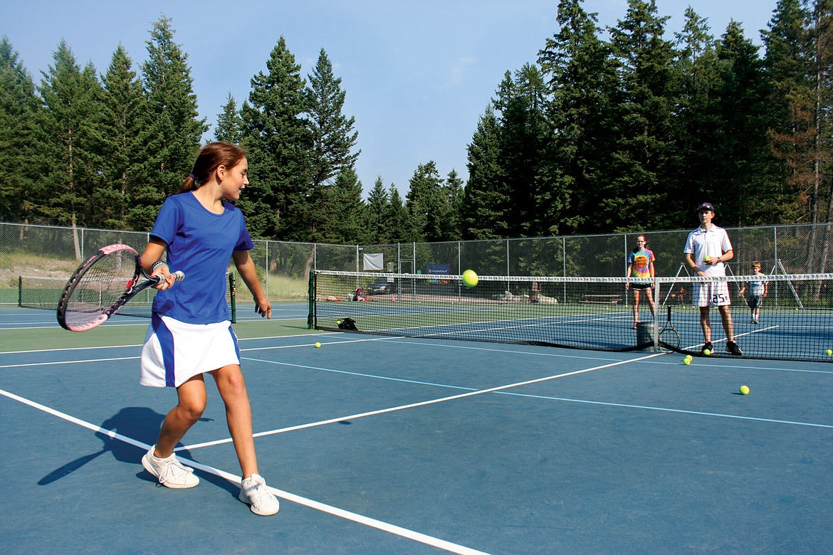 <p>Emma Berreth, 10, takes a swing at a tennis ball in Ben Williams Park in Lakeside during Upward Tennis.</p>