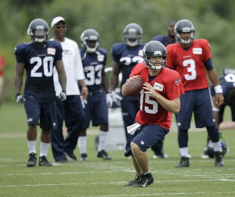 &lt;p&gt;Seattle Seahawks quarterback Matt Flynn (15) passes, as Russell Wilson (3) waits for his turn next at right, Tuesday, Aug. 7, 2012, during NFL football training camp, in Renton, Wash. (AP Photo/Ted S. Warren)&lt;/p&gt;