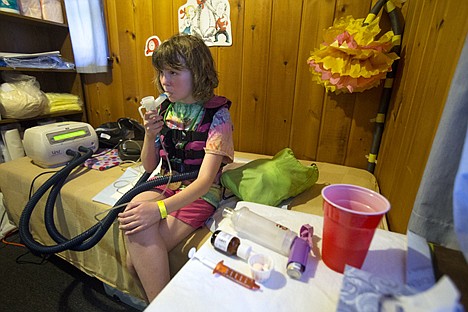 &lt;p&gt;Elaina Nixon, 10, inhales through her nebulizer in the medical cabin at Camp Goodtimes Wednesday.&lt;/p&gt;