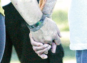 &lt;p&gt;Lynette Rebo, left, holds hands with her mother, Arlyne Beito. The caring hands are a symbol of the survivor-cargiver relationship.&lt;/p&gt;