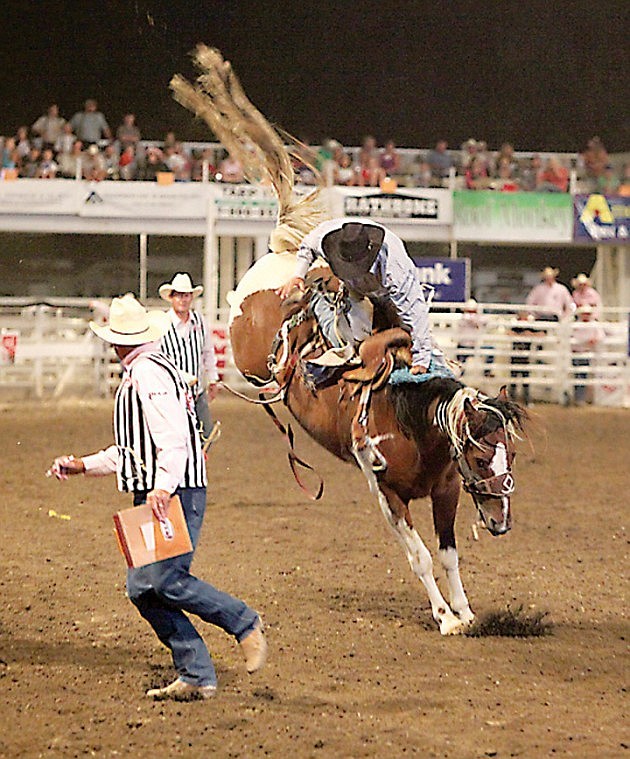 Tucker Lind, of Carlton, Ore., jumps from his horse Thursday night during the Moses Lake Roundup Rodeo.