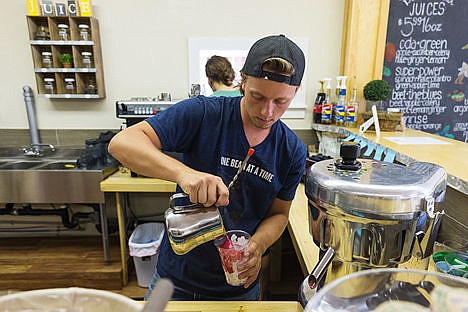 &lt;p&gt;Barista Josh McKibbin pours a fruit and vegetable juice over ice at The Wellness Bar Friday in Coeur d&#146;Alene.&lt;/p&gt;