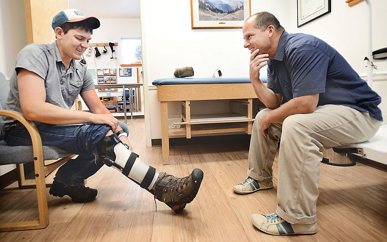 <p>John McCubbins, left, visits with Doug Jack of Northern Care Prosthetics and Orthotics to make adjustments and talk about possible upgrades to his Dynamic Bracing Solutions brace on Friday, July 2, in Kalispell. (Brenda Ahearn/Daily Inter Lake)</p>