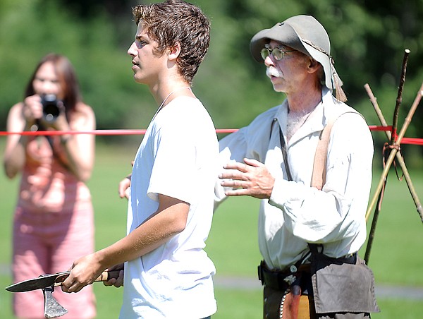 &lt;p&gt;Tyler Coppinger, 15, of Ocean City, Md., center, gets
instructions from Randy Burns of Kalispell, a member of the
Flathead Valley Muzzleloaders, before taking a turn at ax and knife
throwing on Saturday afternoon at the Mountain Man Rendezvous in
Lawrence Park in Kalispell.&lt;/p&gt;