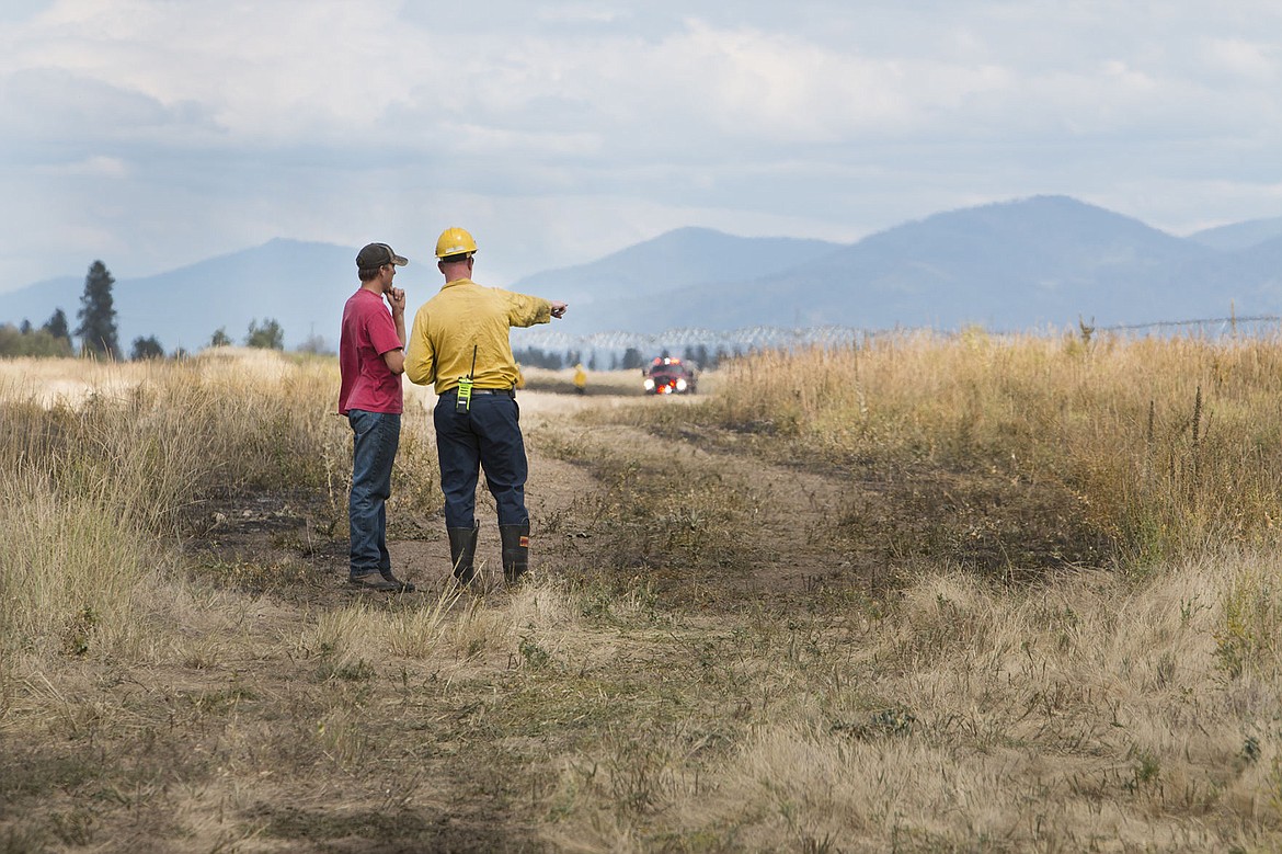 &lt;p&gt;A Spokane Valley fire investigator and the farmer of the property on the Idaho/Washington border that burned Monday afternoon look at the field and talk about what the possible causes and damages were. The Spokane Valley Fire Department received the call at 11:45 a.m. and had a wet line around the area by 12:45 p.m.&lt;/p&gt;