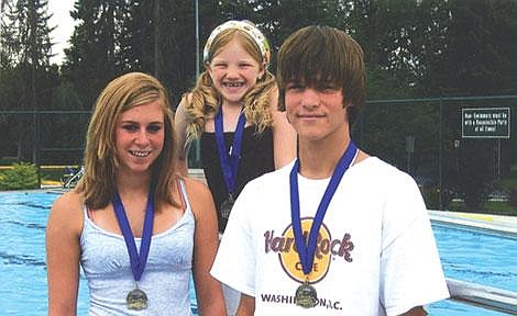 Kalispell Athletic Team Swimmers (from left to right) Kelsey Iblings, Kyersten Siebenaler and Logan Hunter pose with their state-championship medals following the Montana State Long Course Swimming Championship in Bozeman on July 27-29. Photo courtesy of Melanie Iblings