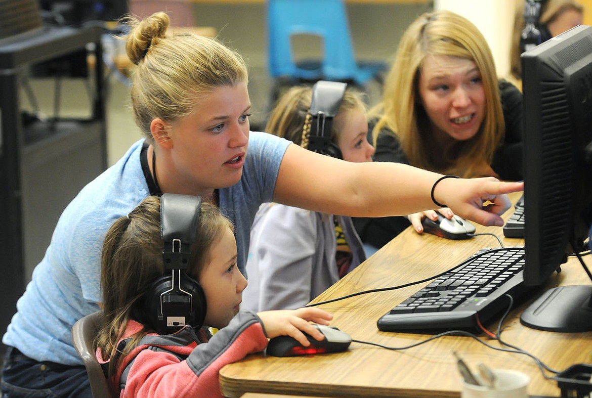 <p>Savannah Miller, a former Hedges student, helps first-grader Jenna Douglas in the computer lab during the Hedges Summer School on Wednesday. (Aaric Bryan/Daily Inter Lake)</p>