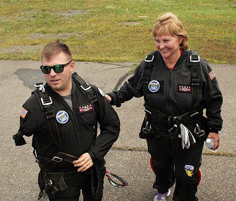 &lt;p&gt;U.S. Army Staff Sgt. Travis Mills, left, walks with Maine's first lady Ann LePage prior to their parachute jump over Fort Kent, Maine, on Saturday. U.S. Army Staff Sgt. Travis Mills, left, walks with Maine's first lady Ann LePage prior to their parachute jump over Fort Kent, Maine, on Saturday.&lt;/p&gt;
