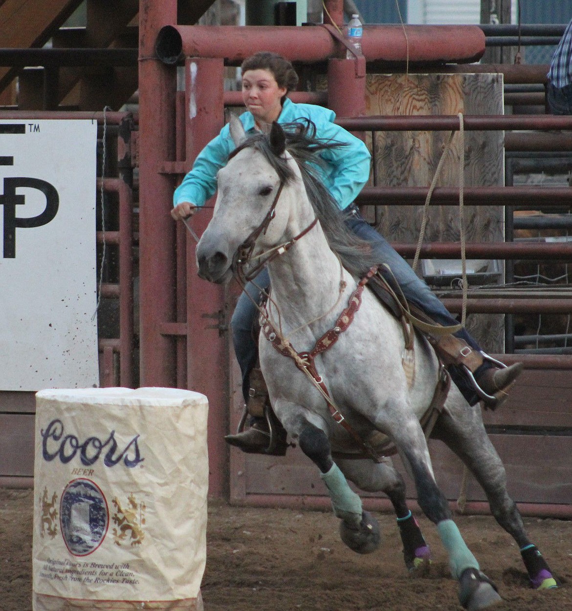 <p>Junior barrel racer, Taylor Jenks from Boulder, takes a turn at the rodeo in Superior on Saturday night.</p>
