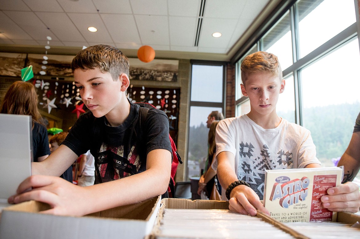 &lt;p&gt;Brayden Moon, left, and Teagan Lang search though stacks of purchasable comic books Saturday at the first-ever Coeur d&#146;Con comic con at the Coeur d&#146;Alene Public Library.&lt;/p&gt;