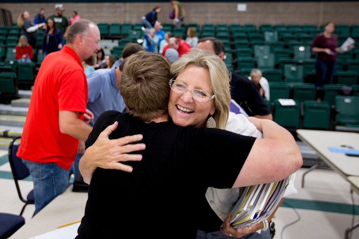 &lt;p&gt;Kelly Ostrom, director of human resources for the Coeur d'Alene School District, receives a hug from Borah Elementary School teacher Kerry Erwin after the district and teachers union came to a tentative agreement over teacher contracts on Wednesday at Woodland Middle School.&lt;/p&gt;