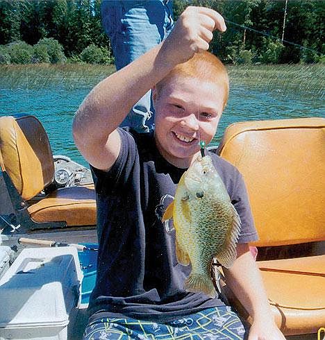 Nate Bache, 10, of Libby on July 30 caught this Montana record-breaking pumpkinseed sunfish at Upper Thompson Lake. The .96-pound fish surpassed the old record set 21 years ago by 1/100th of a pound.
