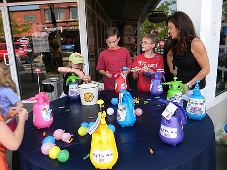 &lt;p&gt;Kids use the Pumponator to fill water balloons Sunday in front of Figpickels in Coeur d'Alene.&lt;/p&gt;