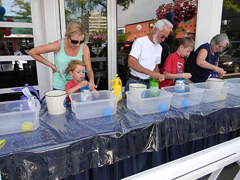 &lt;p&gt;Kids and big kids alike use the Pumponator to fill water balloons Sunday in front of Figpickels in Coeur d'Alene.&lt;/p&gt;