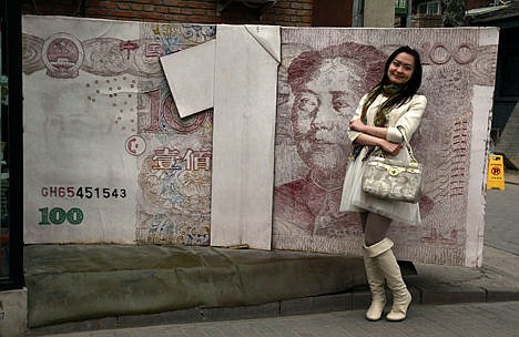 &lt;p&gt;In this March 15, 2012 photo, a Chinese woman poses for photos near a sculpture depicting a Chinese yuan note at an art district in Beijing, China. China devalued its tightly controlled currency on Tuesday, following a slump in trade, triggering the yuan's biggest one-day decline in a decade.&lt;/p&gt;