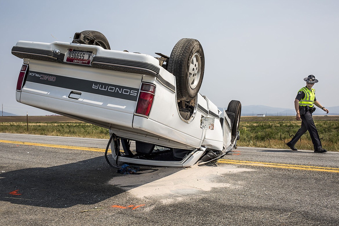 &lt;p&gt;Idaho State Police Trooper Justin Scotch inspects a single-vehicle rollover accident Tuesday, Aug. 5, 2014 on Highway 41 near Wyoming Avenue. The driver, 17-year-old Austin George, the only occupant of the pickup, was heading south on Highway 41 when he failed to maintain his lane, overcorrected and rolled, coming to rest on the roof of the truck. The driver was transported to Kootenai County Medical Center with what appeared to be non-life-threatening injuries.&lt;/p&gt;