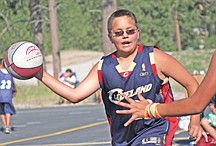 11-year-old Noah McDonald, of Ronan, looks to pass the ball during Midnight Hoopz last Thursday at Two Eagle River High School in Pablo.