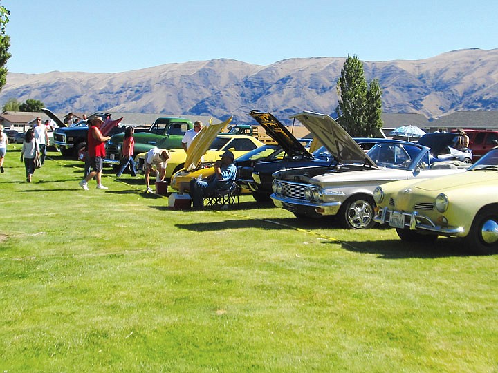 People mill around the numerous cars that were entered in the classic car show.