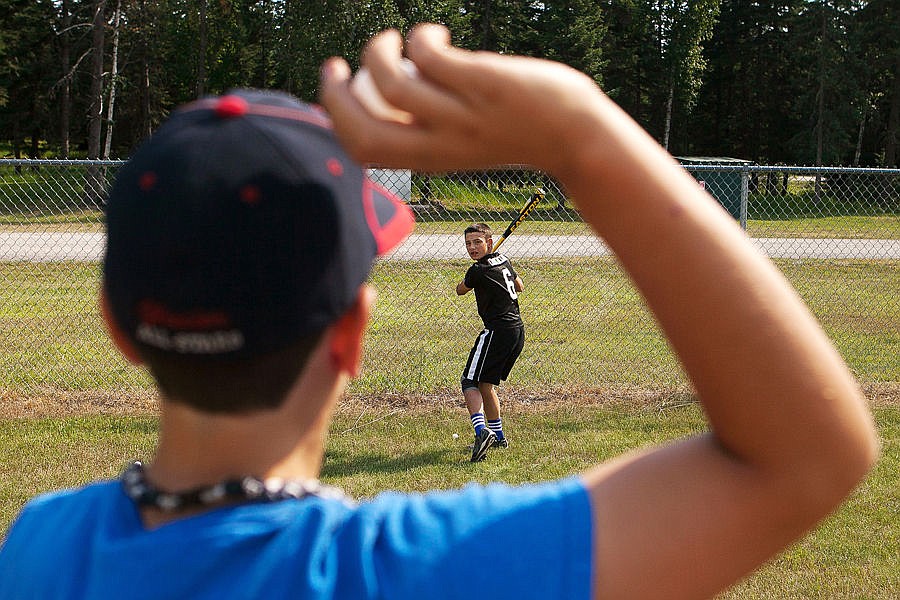 <p>Austin Varner (foreground) and Coby Clark run hitting drills during practice at field near Bigfork on Friday afternoon. Aug. 8, 2014 in Bigfork, Montana. (Patrick Cote/Daily Inter Lake)</p>