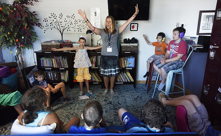 <p>Erin Keithly leads the children as they practice the song on Thursday, July 28 at Pay It Forward Child & Family Services, Inc. in Kalispell. Pay It Forward is a non-profit that works with children offering therapeutic after school and summer programs as well as support groups. They have four fundraisers coming up beginning with the Basler Family Chiropractic event on August 24th. Additional fundraisers are going to be held at Kalispell Brewery from 5-8p.m. on August 30, and at Five Guys Burgers and Fries from 5-7 p.m. on September 13. Plans are in the works for a spaghetti dinner later in Septmeber. (Brenda Ahearn/Daily Inter Lake)</p>