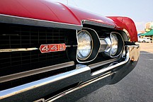 Randy Brandt, Amanda Brandt and Ryan Roark check out the engine of Joe Mauro's '66 Chevy El Camino.