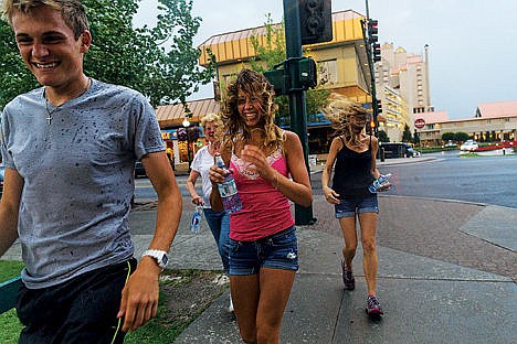 &lt;p&gt;From left, Stephen Bottoms, Shirley Welker, Katie and Lori Lynch briskly walk along the sidewalk near Second Street after crossing Sherman Avenue Tuesday during a sudden storm in Coeur d&#146;Alene.&lt;/p&gt;