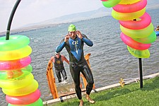 Luke Johnson removes his glasses and Ron Stevens gets out of the water in the background during Water Daze last Saturday in Polson.