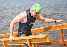 A swimmer runs up the ramp after finishing the race during Water Daze last Saturday in Polson.