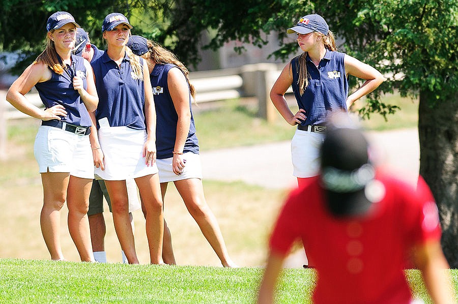 <p>Whitefish's Teigan Avery (left) and Coral Schulz (second from left) along with Montana teammates watch a Canadian competitor finish up on Hole 18 of the south course Wednesday afternoon during the final round of the Montana-Alberta Junior Ryder Cup at Whitefish Lake Golf Club. Aug. 13, 2014 in Kalispell, Montana. (Patrick Cote/Daily Inter Lake)</p>