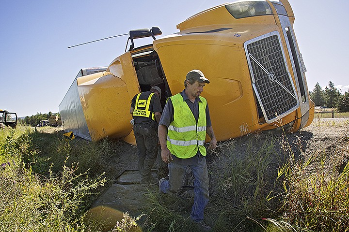 &lt;p&gt;JEROME A. POLLOS/Press A.J. Landingham, with Merwin's Towing, walks around the cab of a semi-truck that overturned Friday north of Hayden on Highway 53 west of US 95. The driver of the truck was uninjured in the accident that took nearly six hours to clear as crews removed the hay bales from the enclosed trailer and pulled the truck and trailer back on its wheels.&lt;/p&gt;