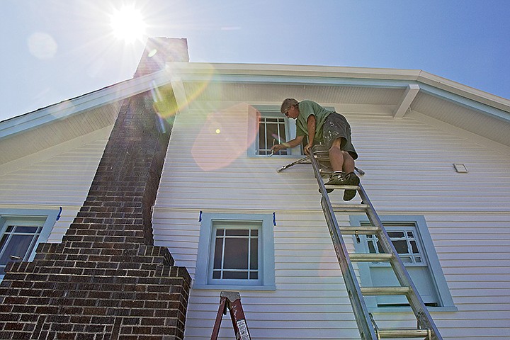 &lt;p&gt;JEROME A. POLLOS/Press Marvin Jasmin works in the shade from a ladder as he applies a second coat of paint to the trim of an 89-year-old home Tuesday in midtown Coeur d'Alene.&lt;/p&gt;