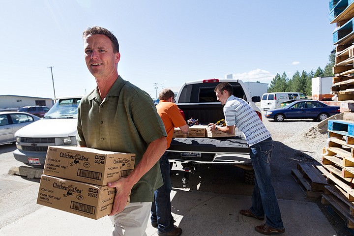 &lt;p&gt;SHAWN GUST/Press Ben Miller carries an armload of food into Community Action Partnership Friday as members of the Coeur Group deliver more than 250 pounds of canned tuna fish to the food bank. The group divided a donation totaling $650 between the Post Falls and Coeur d'Alene food banks in response Thursday's Press news story.&lt;/p&gt;