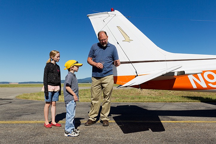 &lt;p&gt;SHAWN GUST/Press Pilot Mike Kohl decries the function of the trim tab of his Cessna Friday to Teague Caro, 6, and his sister Madeline, 10, both Phoenixes in the Special Opportunities Affirm Recognition in Noteworthy Goals program, in its 18th year in Coeur d'Alene. Through the program and the help of community volunteers, each child had a chance to co-pilot the small aircraft.&lt;/p&gt;