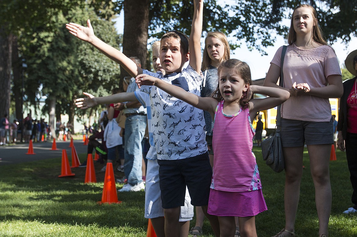 &lt;p&gt;Caleb and Anna Torgenson, eight and five-years-old respectively, offered high-fives and a &#147;you can this&#148; to everyone who passed at the Coeur d&#146;Alene Triathlon Saturday. The two came to support their dad, Marcus. Photo by Bethany Blitz.&lt;/p&gt;