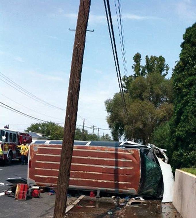 A van sits in the middle of Division Street Friday after a rollover crash in Moses Lake. The Moses Lake man arrested in the crash allegedly assaulted a nurse afterward.