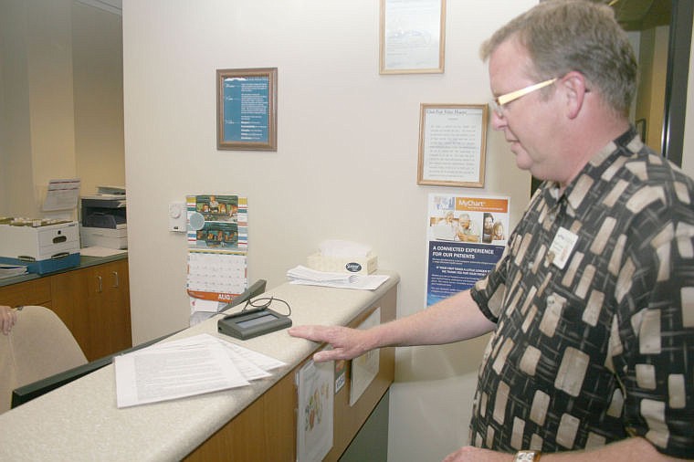 &lt;p&gt;Russell Logan shows how patients will sign in electronically on the digital pad at the front desk.&lt;/p&gt;