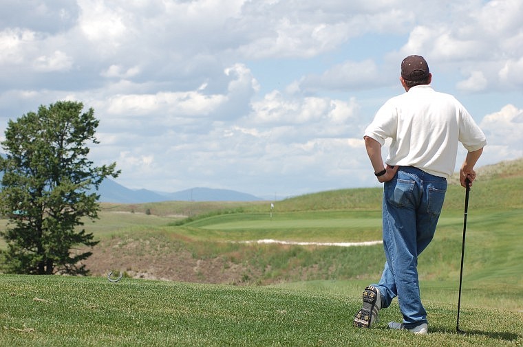 Indian Springs Ranch Golf Club shop manager Brian Berg looks out onto the par 3 sixth hole before teeing off on June 24. Indian Springs is in its first full summer of operation and offers 18 holes of links style golf in Eureka.