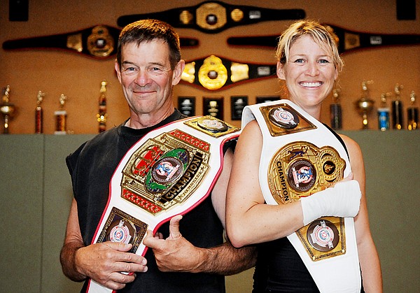 Kalispell residents Ed Wettach (left) and Jen Johnson pose at the Montana Straight Blast Gym with the Ringside World Championship belts they won in Kansas City, Mo., in early Aug.