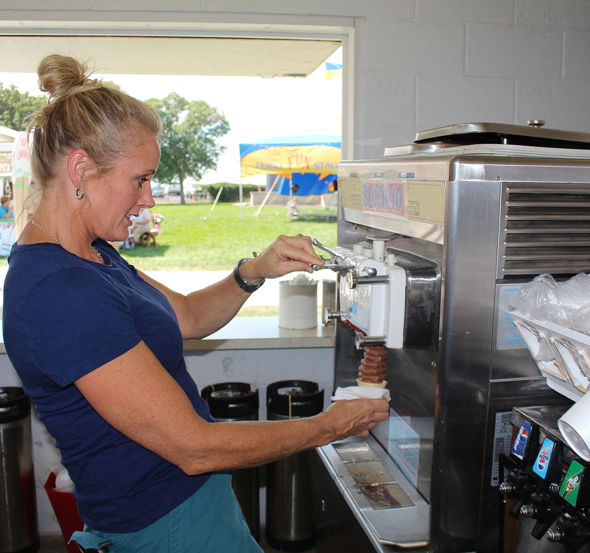 A volunteer makes an ice cream cone in the Block 40 booth at the 2015 Grant County Fair.