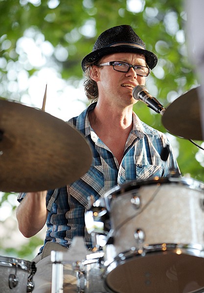 <p>Don Caverly of Mood Iguana playing drums and backing up lead singer Andre Floyd on Thursday, August 7, in Kalispell.</p>