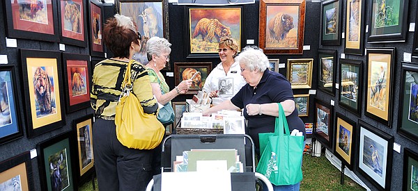 Maureen Cordoza of Whitefish, left to right, Mary Huggans of Pauls Valley, Okla., artist Pat Branting of Bozeman and Mary Ann Chapman of Whitefish, chat as they look over Branting's work on Saturday at the 21st Annual Huckleberry Days Arts Festival in Whitefish.