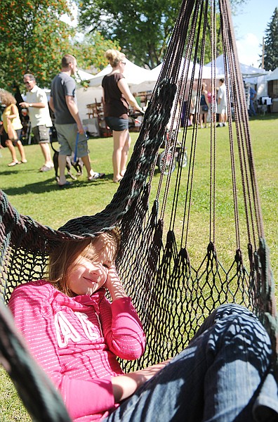 Ashley Hale, 9, of Bozeman relaxes in one of the Hangloose Hammocks on display on Saturday at the 21st Annual Huckleberry Days Arts Festival in Whitefish.