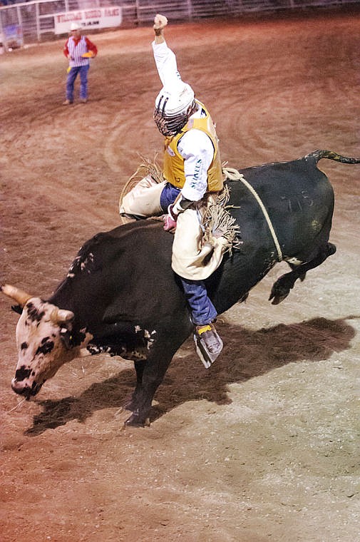 <p>Shaun Halko of Bozeman scores an 80 during his bull ride Thursday night during the first night of the Northwest Montana Fair PRCA Rodeo at the Flathead County Fairgrounds. </p>
